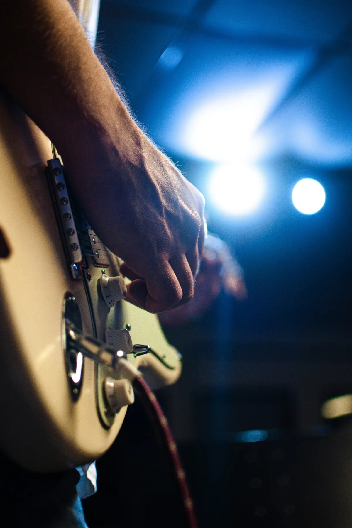 Guitarist playing an acoustic guitar on stage